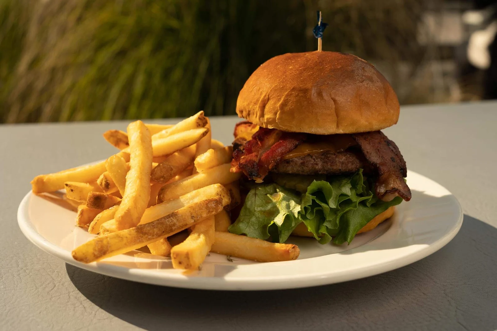 Avocado bacon burger with golden fries