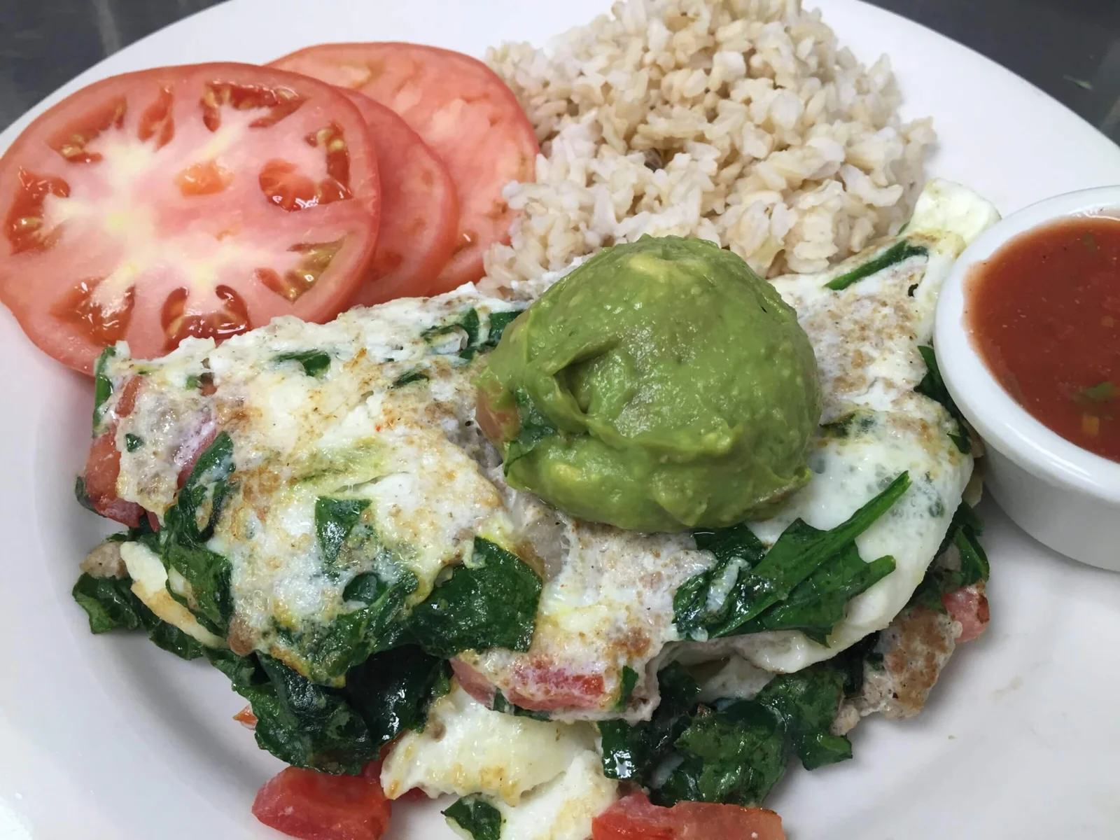 Beach Body Omelette with avocado, tomatoes, and a side of rice